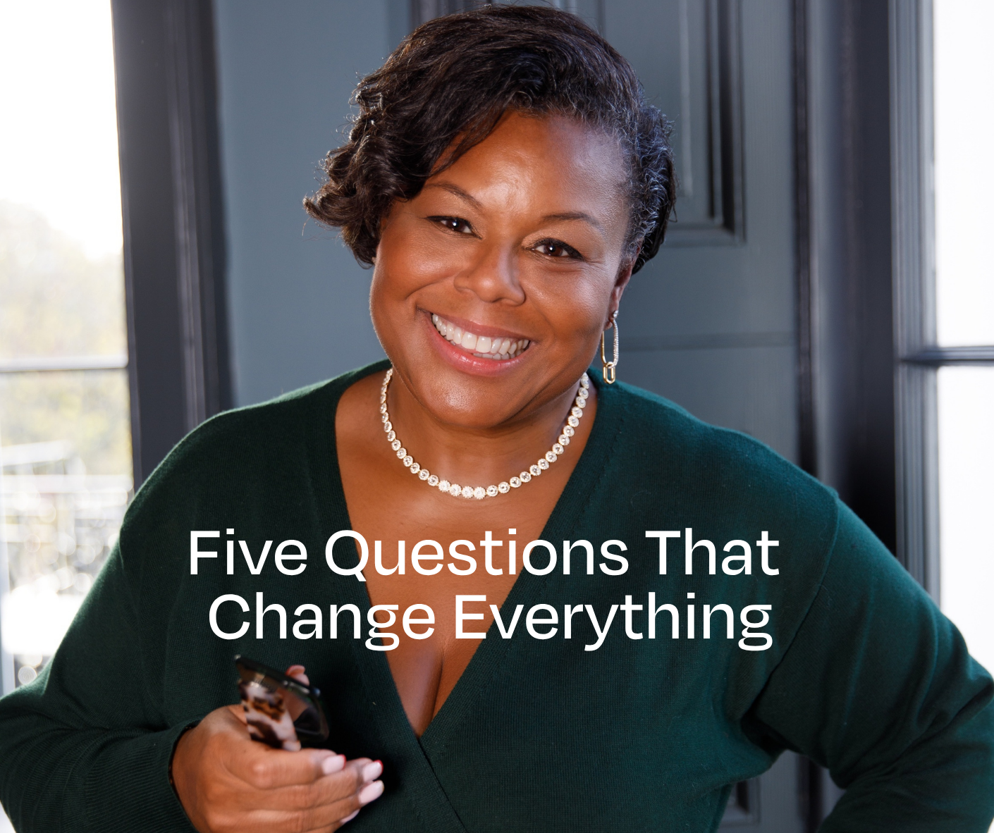 Madeline McQueen holding her glasses - wording Five Questions That Change Everything